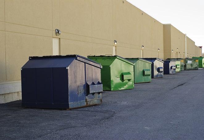 large construction dumpster positioned on a city street in Boylston, MA